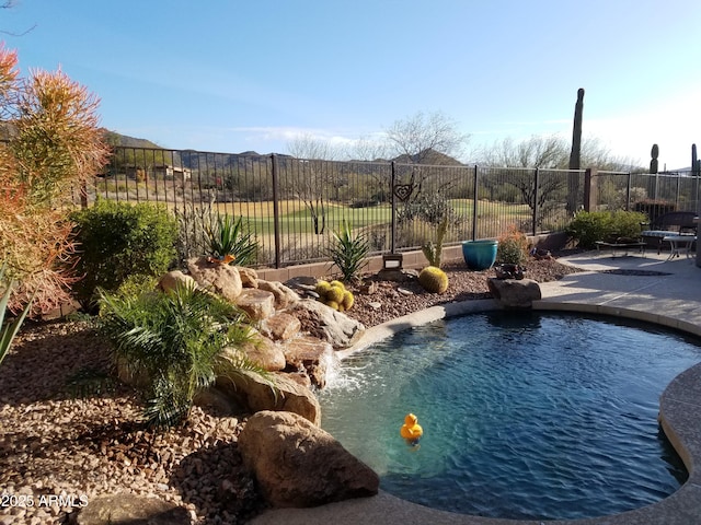 view of pool with a patio area and pool water feature