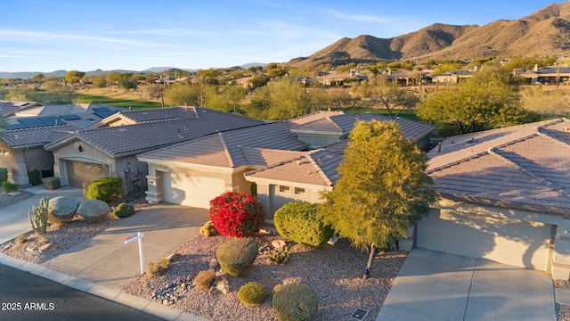 view of front of house featuring a garage and a mountain view