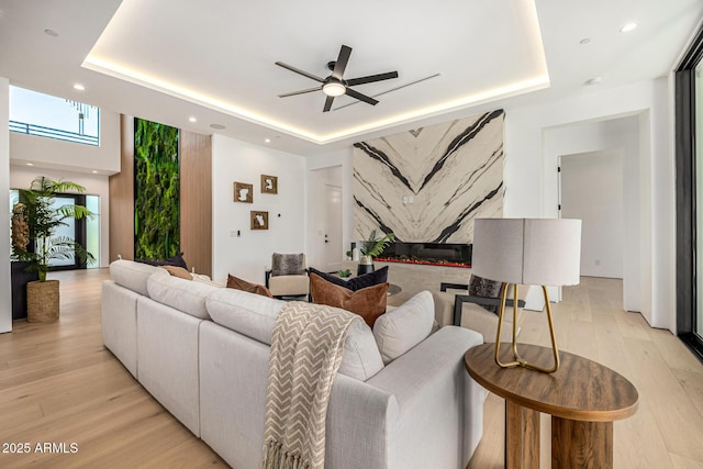 8038 E Clarendon Ave, Scottsdale, AZ 85251 - living area featuring a raised ceiling, ceiling fan, light wood-type flooring, and recessed lighting