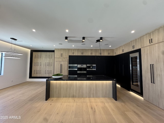 8038 E Clarendon Ave, Scottsdale, AZ 85251 - kitchen featuring light brown cabinetry, beverage cooler, a spacious island, dark countertops, and light wood-style flooring