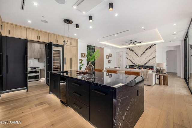 8038 E Clarendon Ave, Scottsdale, AZ 85251 - kitchen with ceiling fan, light brown cabinetry, light wood-style flooring, a tray ceiling, and recessed lighting