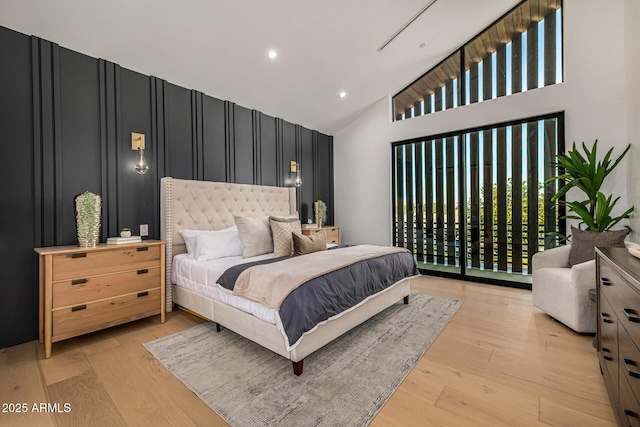 8038 E Clarendon Ave, Scottsdale, AZ 85251 - bedroom featuring light wood-type flooring, high vaulted ceiling, recessed lighting, and an accent wall
