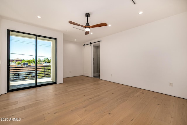 8038 E Clarendon Ave, Scottsdale, AZ 85251 - spare room featuring a barn door, light wood-type flooring, ceiling fan, and recessed lighting