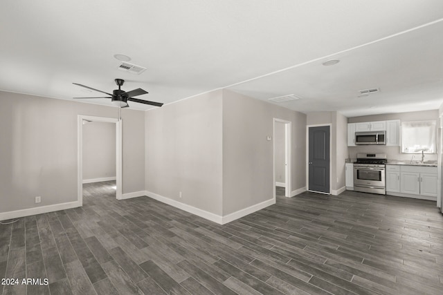 unfurnished living room with dark wood-type flooring and ceiling fan