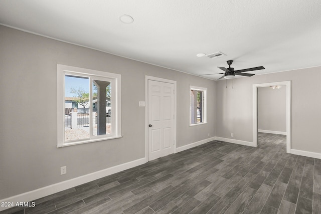 entrance foyer with plenty of natural light, ceiling fan, and dark wood-type flooring