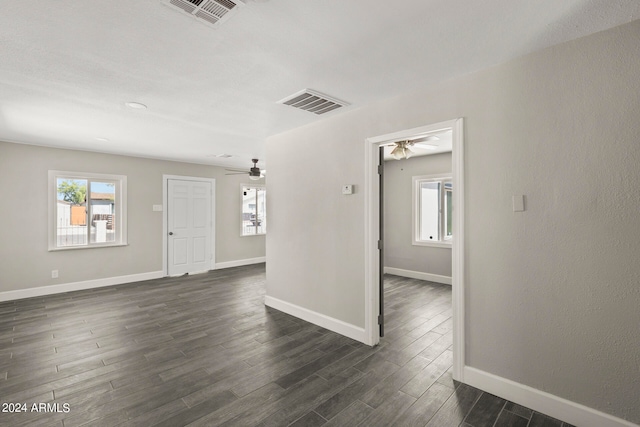 unfurnished room with ceiling fan and dark hardwood / wood-style floors