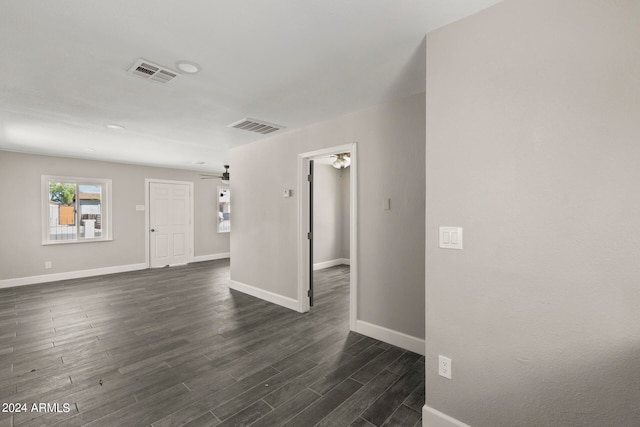 unfurnished room featuring ceiling fan and dark hardwood / wood-style flooring