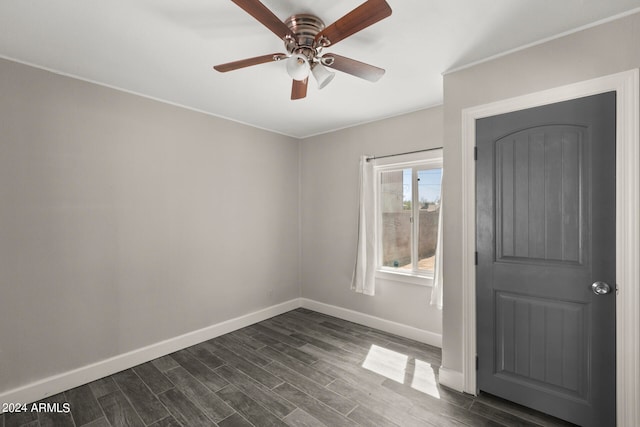 spare room featuring ceiling fan and dark hardwood / wood-style floors