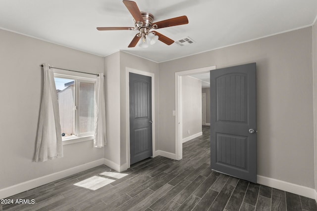 unfurnished room featuring ceiling fan and dark hardwood / wood-style floors