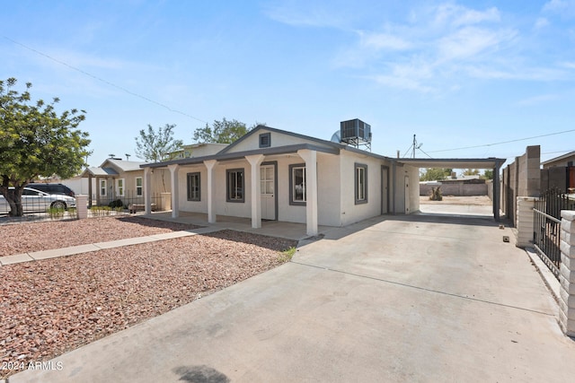 view of front of house featuring a carport and cooling unit