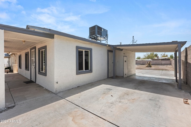 back of property featuring cooling unit and a patio