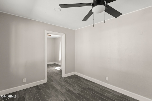 empty room featuring ceiling fan and dark hardwood / wood-style floors