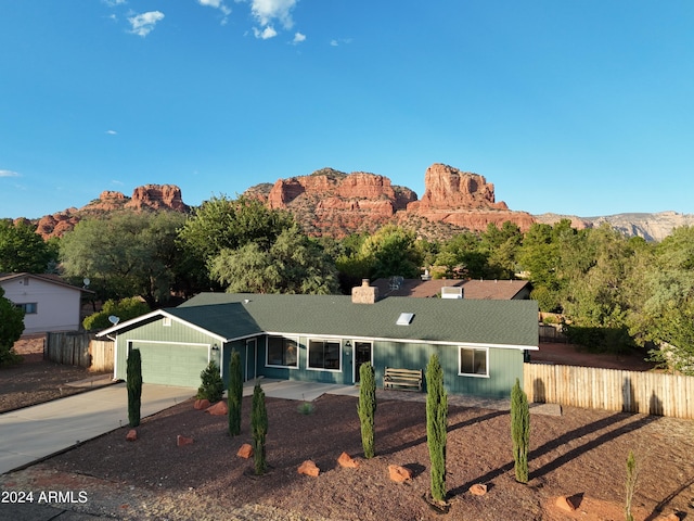 ranch-style house with a mountain view and a garage