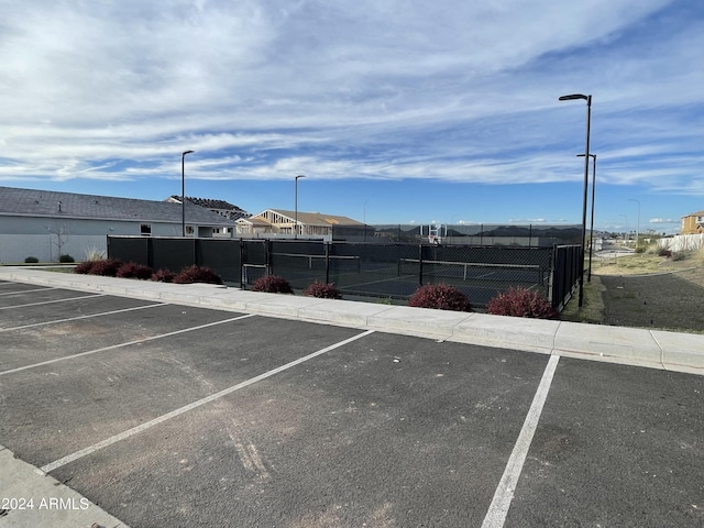 view of parking / parking lot with tennis court