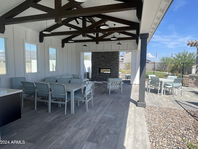 view of patio / terrace featuring an outdoor living space with a fireplace and ceiling fan