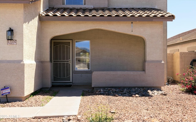 12209 W Washington St, Avondale, AZ 85323 - entrance to property with stucco siding, a tiled roof, and fence