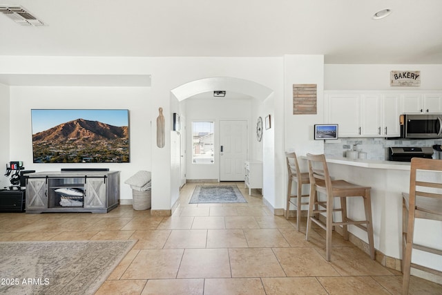 12209 W Washington St, Avondale, AZ 85323 - entryway with arched walkways, light tile patterned flooring, baseboards, and a mountain view