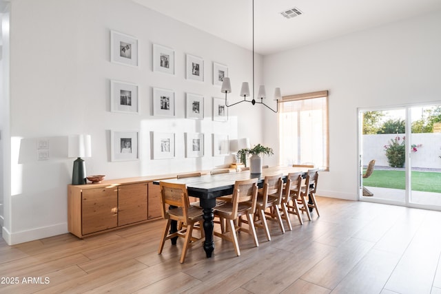 2982 S Holguin Way, Chandler, AZ 85286 - dining area featuring light wood-style floors, baseboards, and a chandelier
