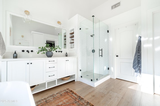 2982 S Holguin Way, Chandler, AZ 85286 - bathroom featuring wood finished floors, a stall shower, and double vanity