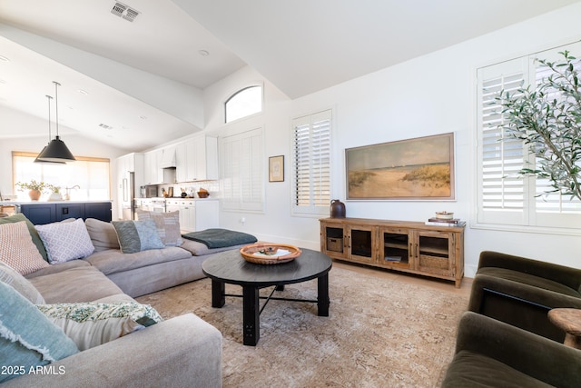 2982 S Holguin Way, Chandler, AZ 85286 - living area with lofted ceiling, baseboards, and light wood-style flooring