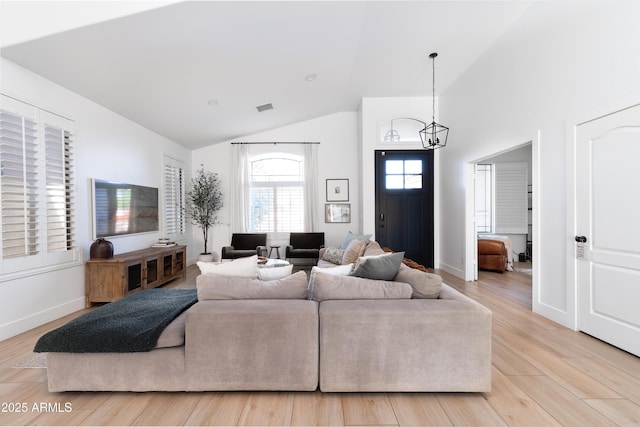 2982 S Holguin Way, Chandler, AZ 85286 - living room with a chandelier, high vaulted ceiling, light wood-type flooring, and baseboards