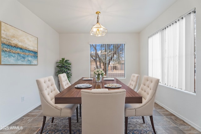 dining room with an inviting chandelier and baseboards