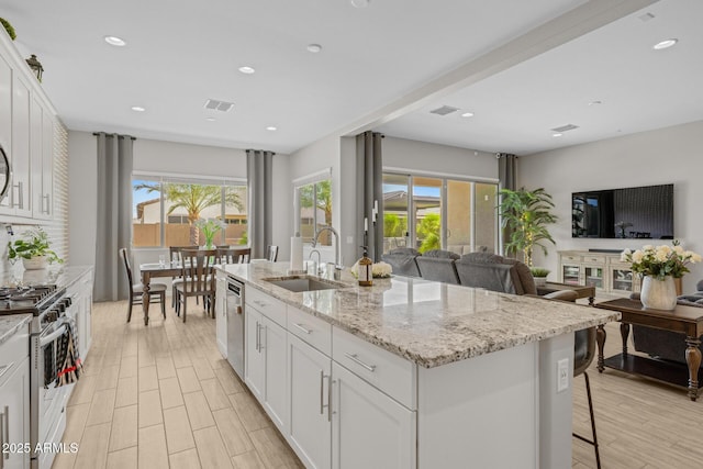 2343 E Kelly Dr, Gilbert, AZ 85298 - kitchen with a sink, appliances with stainless steel finishes, open floor plan, white cabinetry, and recessed lighting