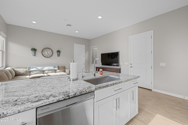 2343 E Kelly Dr, Gilbert, AZ 85298 - kitchen with stainless steel dishwasher, open floor plan, a sink, white cabinets, and recessed lighting