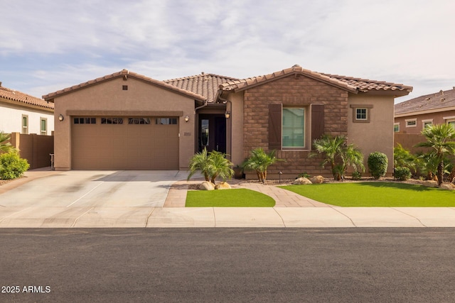 2343 E Kelly Dr, Gilbert, AZ 85298 - view of front facade featuring a garage, concrete driveway, a tiled roof, stucco siding, and stone siding