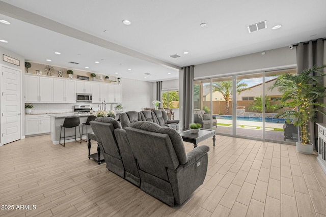 2343 E Kelly Dr, Gilbert, AZ 85298 - living room featuring light wood-type flooring and recessed lighting
