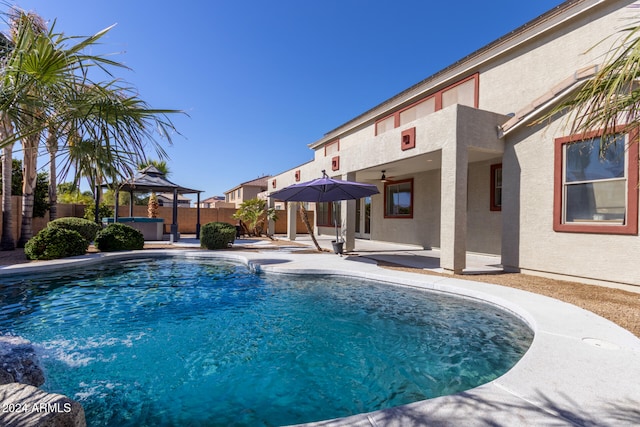 view of swimming pool with a gazebo, a patio area, and a jacuzzi