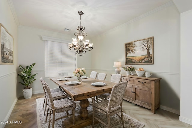 dining space featuring baseboards, visible vents, a chandelier, and ornamental molding