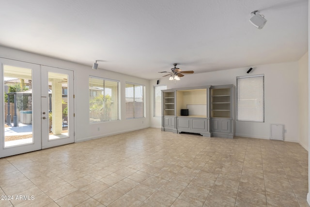 unfurnished living room featuring french doors, ceiling fan, baseboards, and light tile patterned floors