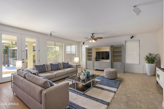 living room featuring light tile patterned floors, a ceiling fan, and french doors