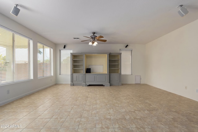 unfurnished living room featuring ceiling fan, light tile patterned floors, visible vents, and baseboards