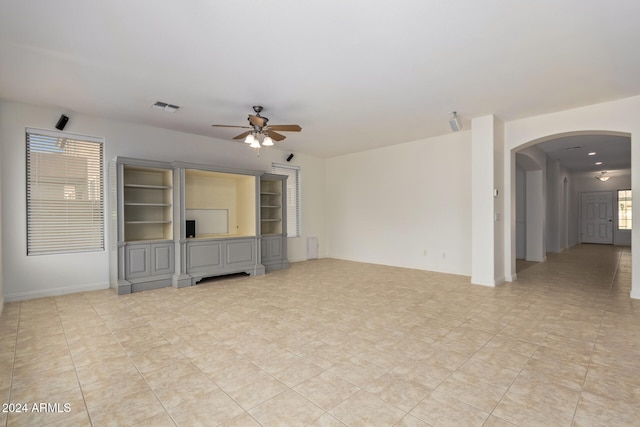 unfurnished living room with ceiling fan and light tile patterned flooring