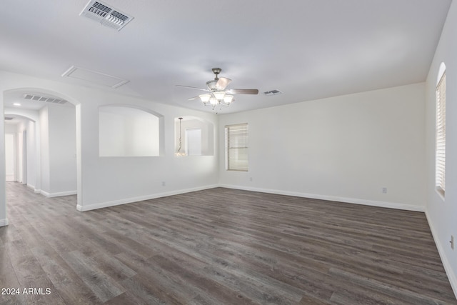 empty room with ceiling fan and dark hardwood / wood-style flooring