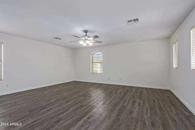 spare room featuring ceiling fan and dark wood-type flooring