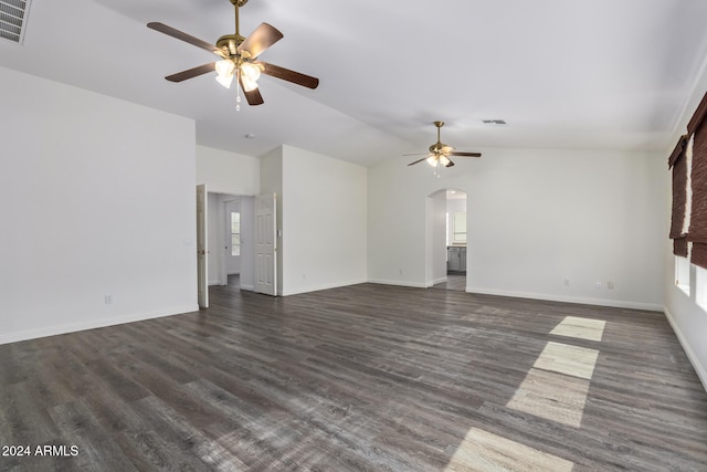 unfurnished living room with ceiling fan, visible vents, arched walkways, and dark wood finished floors