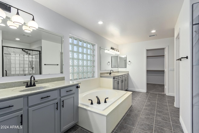 bathroom with tile patterned flooring, a sink, visible vents, and a shower stall