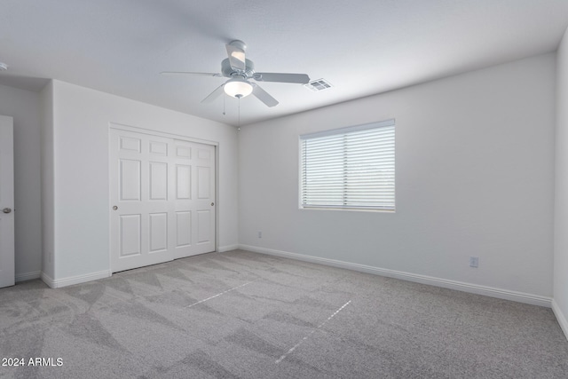 unfurnished bedroom featuring carpet floors, visible vents, and baseboards