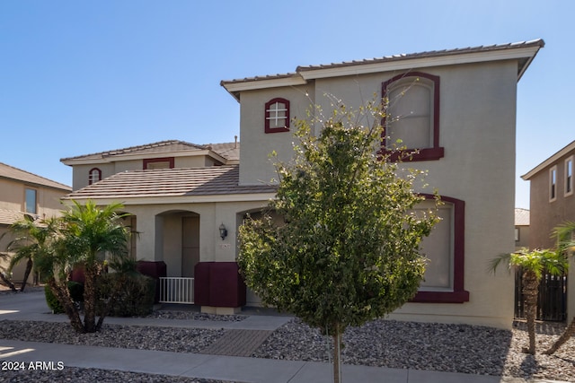 mediterranean / spanish-style house with a tile roof and stucco siding