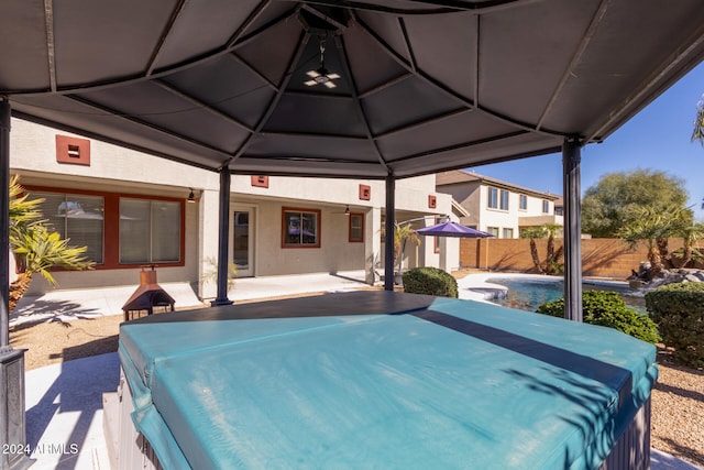 view of patio with fence and a pool