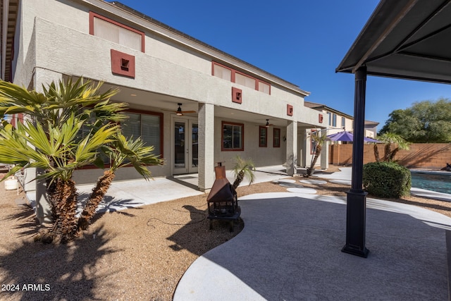 back of house with french doors, stucco siding, a patio area, ceiling fan, and fence