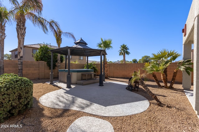 view of patio / terrace with a gazebo and a hot tub