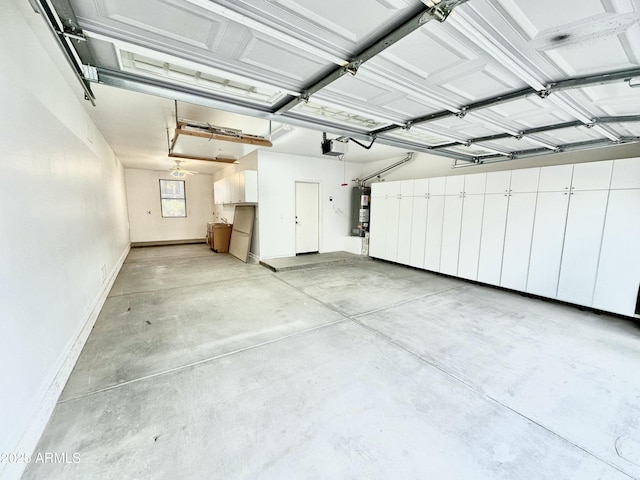 garage with a garage door opener, strapped water heater, and baseboards