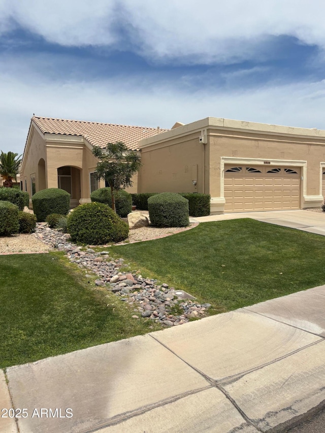 8426 W Utopia Rd, Peoria, AZ 85382 - view of front facade with concrete driveway, an attached garage, a front yard, stucco siding, and a tiled roof