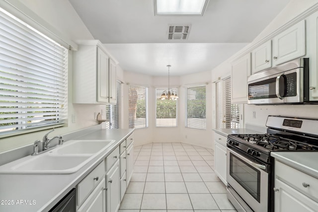 8426 W Utopia Rd, Peoria, AZ 85382 - kitchen featuring stainless steel appliances, a sink, a chandelier, white cabinetry, and light countertops