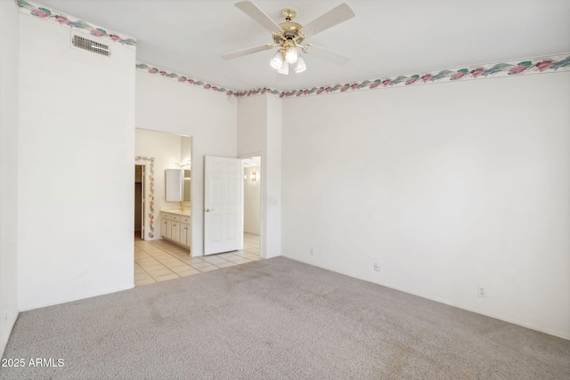 8426 W Utopia Rd, Peoria, AZ 85382 - spare room featuring light colored carpet, a ceiling fan, and light tile patterned floors