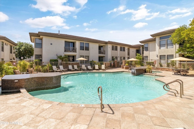 view of pool with a patio and pool water feature